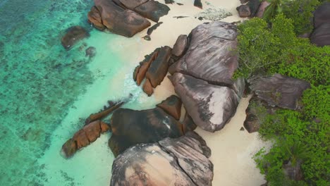 Buge-rock-boulders-on-baie-lazare-beach,-a-beach-located-on-Mahe-island-on-the-south-west-coast,-turquoise-water,-white-sandy-beach