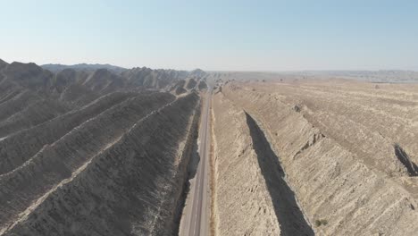 Aerial-View-Over-N10-Makran-Coastal-Highway-Road-With-Dramatic-Rock-Formations-On-Either-Side-In-Hingol-National-Park
