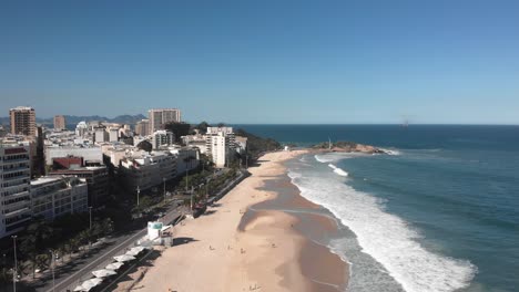 Aerial-view-of-Ipanema-with-waves-coming-in-on-the-reopened-beach-with-people-returning-to-activities-and-enjoy-outdoors-during-COVID-19-Coronavirus-outbreak