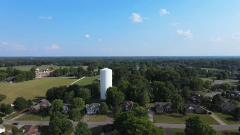 Flying-over-houses-toward-water-tower-with-drone