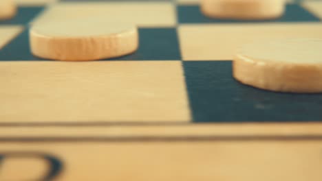 Pan-macro-close-up-shot-of-a-wooden-board-of-a-draughts-checkers-strategy-game,-4K