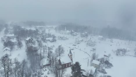 Aerial-flight-over-the-two-churches-of-Snow-covered-Monson