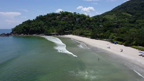 Aerial-view-over-waves-at-the-Barra-Do-Sahy-beach,-in-sunny-Brazil