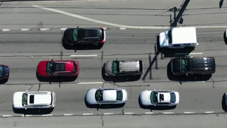 Aerial-birds-eye-view-directly-above-three-lane-highway,-stop-and-go-traffic-jam-congestion