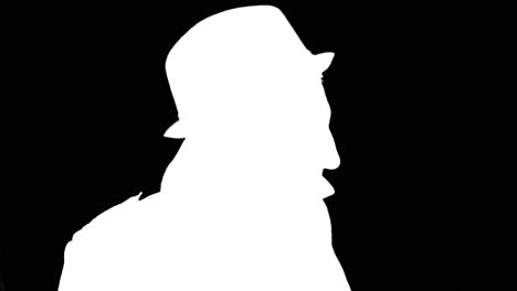 Mysterious-man-in-coat-and-hat-turning-around,-white-silhouette-on-black-background