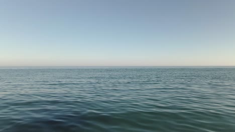 Vast-huge-open-ocean-seascape-blue-water-calm-wave-surface-looking-out-to-horizon