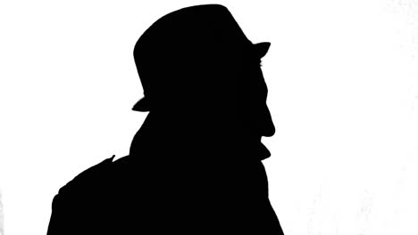 Mysterious-man-in-coat-and-hat-turning-around,-black-silhouette-on-white-background