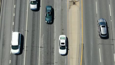 Aerial-top-down-perspective-of-traffic-on-multi-lane-highway,-roadway