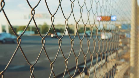 Blurred-traffic-highway-with-metal-chain-fence-after-coronavirus-lockdown