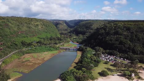 Waimea-Bay---River-on-Tropical-Island-of-Oahu,-Hawaii---Tilt-Down-Aerial-Reveal