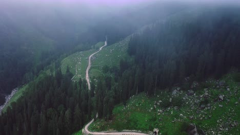 Beautiful-aerial-shot-of-drone-moving-through-clouds-revealing-river---road