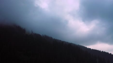 Aerial-footage-of-looking-up-into-the-clouds-from-a-road-diverging-into-woods-in-himachal-pradesh