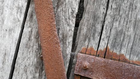 Grungy-vintage-damaged-wooden-textured-timber-and-rusty-aged-steel-supports-backdrop-dolly-slow-right