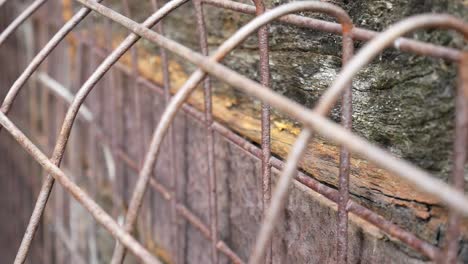 Rustic-vintage-weathered-wooden-textured-timber-and-rusted-steel-cage-mesh-dolly-left-closeup