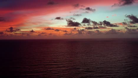 Aerial-drone-time-lapse-of-a-stunning-golden-pink-and-orange-sunrise-with-the-vast-ocean-below-on-a-warm-summer-morning-in-Northern-Brazil-near-Joao-Pessoa