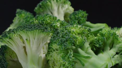 Broccoli-pieces-rotating-on-black-background,-Close-Up-Detail-Shot