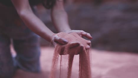 Close-up-hands-grabbing-sand,-arid-desert,-Wadi-Rum,-Jordan,-static-shot