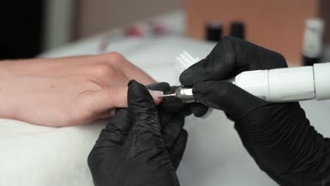 Using-an-electric-drill-to-remove-cuticle-in-a-manicure-salon