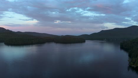 Aerial-shot-of-a-lake-at-dusk-with-beautiful-colors-in-the-Eastern-Township,-Quebec,-Canada