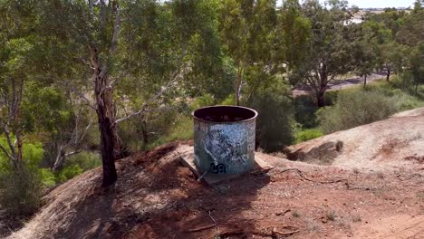 Garbage-Can-And-A-Small-Tree-On-The-Hill-In-Clonlea-Park,-Gawler,-South-Australia---orbiting-shot