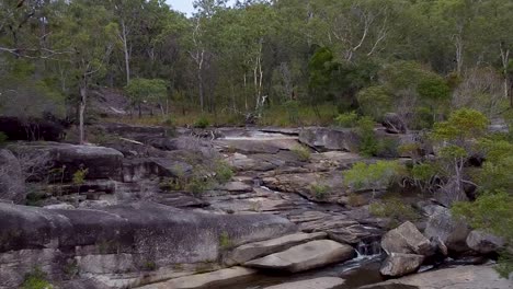 The-stunning-Davies-Creek-Falls,-the-perfect-relaxing-nature-getaway---aerial-reverse