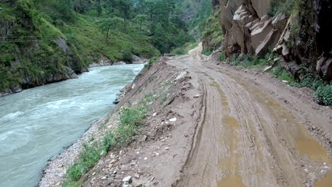 POV-Walking-along-dirt-road-by-a-wild-river-in-the-mountains-in-Nepal