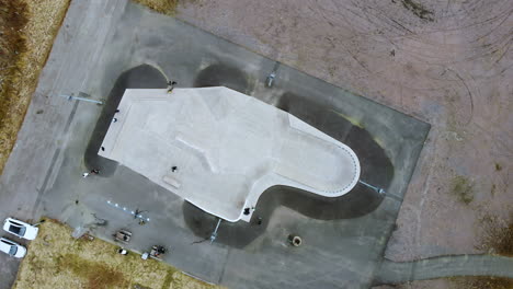 Top-View-Of-A-Skatepark-In-Kållered,-Mölndal,-Sweden-With-Few-People-And-A-Skater---aerial-drone