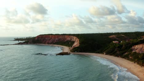 Beautiful-aerial-drone-rising-shot-of-the-large-tropical-colorful-cliffs-on-the-exotic-beach-of-Tabatinga-in-Northern-Brazil-near-Joao-Pessoa-on-a-warm-summer-day