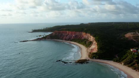 Beautiful-aerial-drone-shot-of-the-large-tropical-colorful-cliffs-on-the-exotic-beach-of-Tabatinga-in-Northern-Brazil-near-Joao-Pessoa-on-a-warm-summer-day