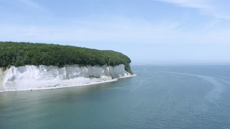 Drone-Aerial-Shot-of-the-chalk-cliffs-on-Ruegen-Rügen-in-Germany-in-beautiful-light-with-green-and-blue-seawater,-Europe
