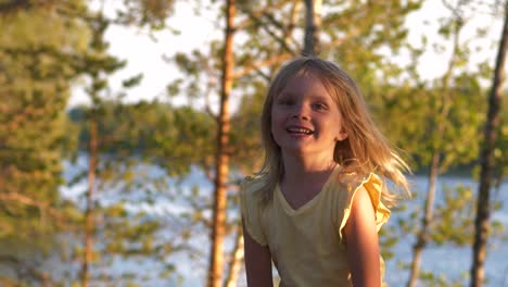 Smiling-young-girl-in-forest-in-sun,-slow-motion