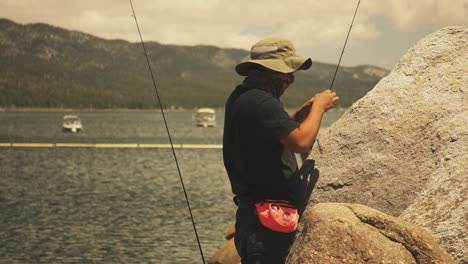 Fisherman-taking-is-time-in-preparing-the-hook-with-the-bait-on-Big-Bear-Lake