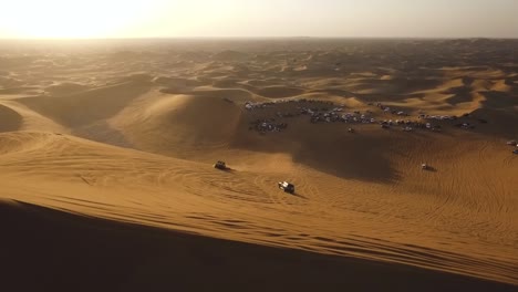People-standing-on-a-big-sand-dune,-motocross-quad-bikes