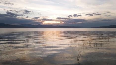 Dramatic-sunset-over-Utah-Lake,-low-aerial-4K-footage