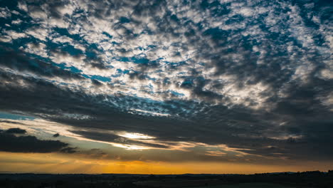 Clouds-pass-by-in-a-time-lapse-of-a-glorious-Sunset-on-a-June-evening-over-Worcestershire,-England,-UK