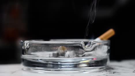 a-cigarette-is-placed-in-an-ashtray