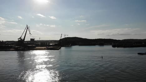 Aerial-drone-of-industrial-Gothenburg-port-on-sunny-morning,-Sweden