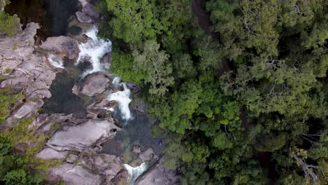 Aerial-Top-Down-View-Over-Behana-Gorge-Surrounded-By-Trees-With-Water-Flowing-Down