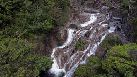 Aerial-View-Of-Behana-Waterfall-With-Water-Cascading-Down-Rock-Face