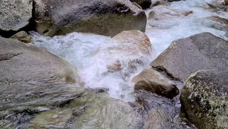 Low-Angle-View-Of-Water-Flowing-Over-Rocks-At-Josephine-Falls,-Cairns,-Australia