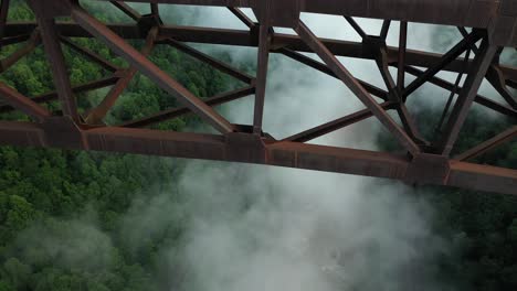 Close-Up-Aerial-View-of-Steel-Bridge-Arch-and-Clouds-Above-River-Canyon,-West-Virginia-USA