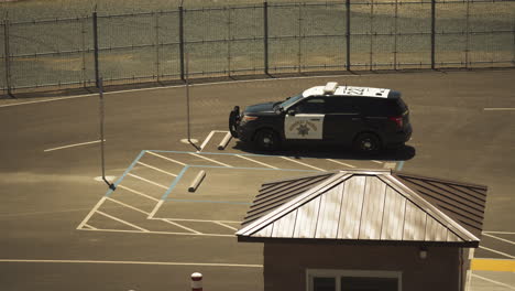 American-highway-patrol-cruiser-parked-at-Oroville-dam-station,-static-shot