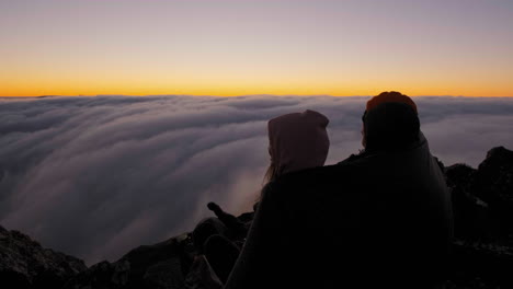 Hikers-bonding-and-enjoying-the-dusk,-above-clouds-on-Mount-Hassell,-in-West-Australia