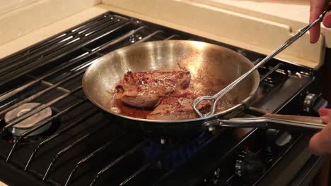 Butterflied-lion-steak-frying-in-a-skillet-on-a-stove-top