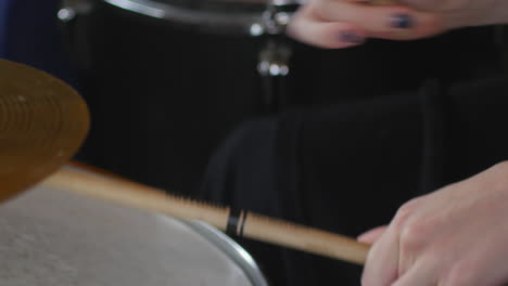 Sticks-blur-as-drummer-twirls-them-through-fingers-while-playing-drums