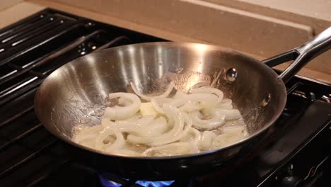 Butter-melting-in-a-saute-pan-of-sliced-onions