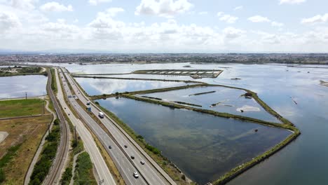 Aerial-view-of-a-Highway-road-surrounded-by-river-channels-and-land-lines