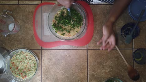 Mixing-herbs-into-a-traditional-recipe-for-homemade-meatloaf---top-down-view