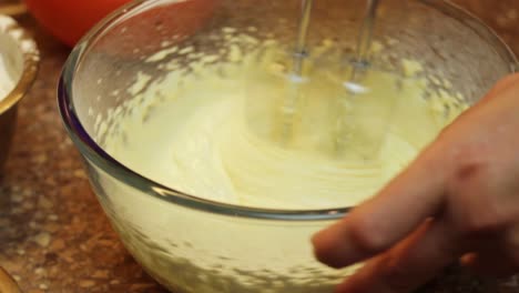 Combining-sugar-egg-yolk-with-hand-mixer-for-cake