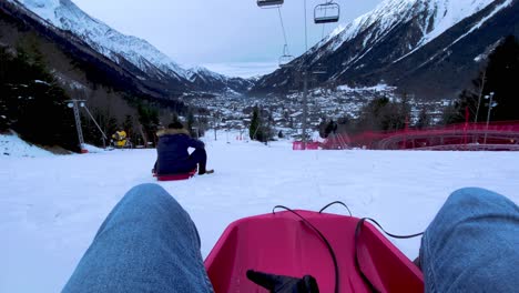 Riders-Resting-On-The-Snow-Sleds-In-Chamonix,-France-On-A-Cold-Winter-Day---wide-shot